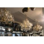 A SET OF THREE GILT METAL AND CRYSTAL EIGHT BRANCH CHANDELIERS. (75cm) Condition: some prisms