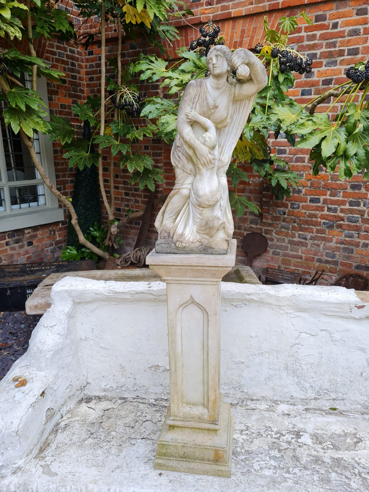 A 19TH CENTURY MARBLE STATUE, SAINTLY FIGURE WITH CHILD On a tapering pedestal. (25cm x 25cm x