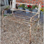 A 19TH CENTURY WROUGHT IRON STRAPWORK GARDEN BENCH Having scrolled arms and white painted finish. (