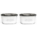 A LARGE PAIR OF STAINLESS STEEL OVAL CHAMPAGNE BUCKET Engraved with a coat of arms and the motto,