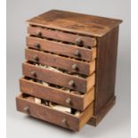 A LATE 19TH/EARLY 20TH CENTURY SPECIMEN COLLECTION IN A SIX DRAWER CHEST. The contents including