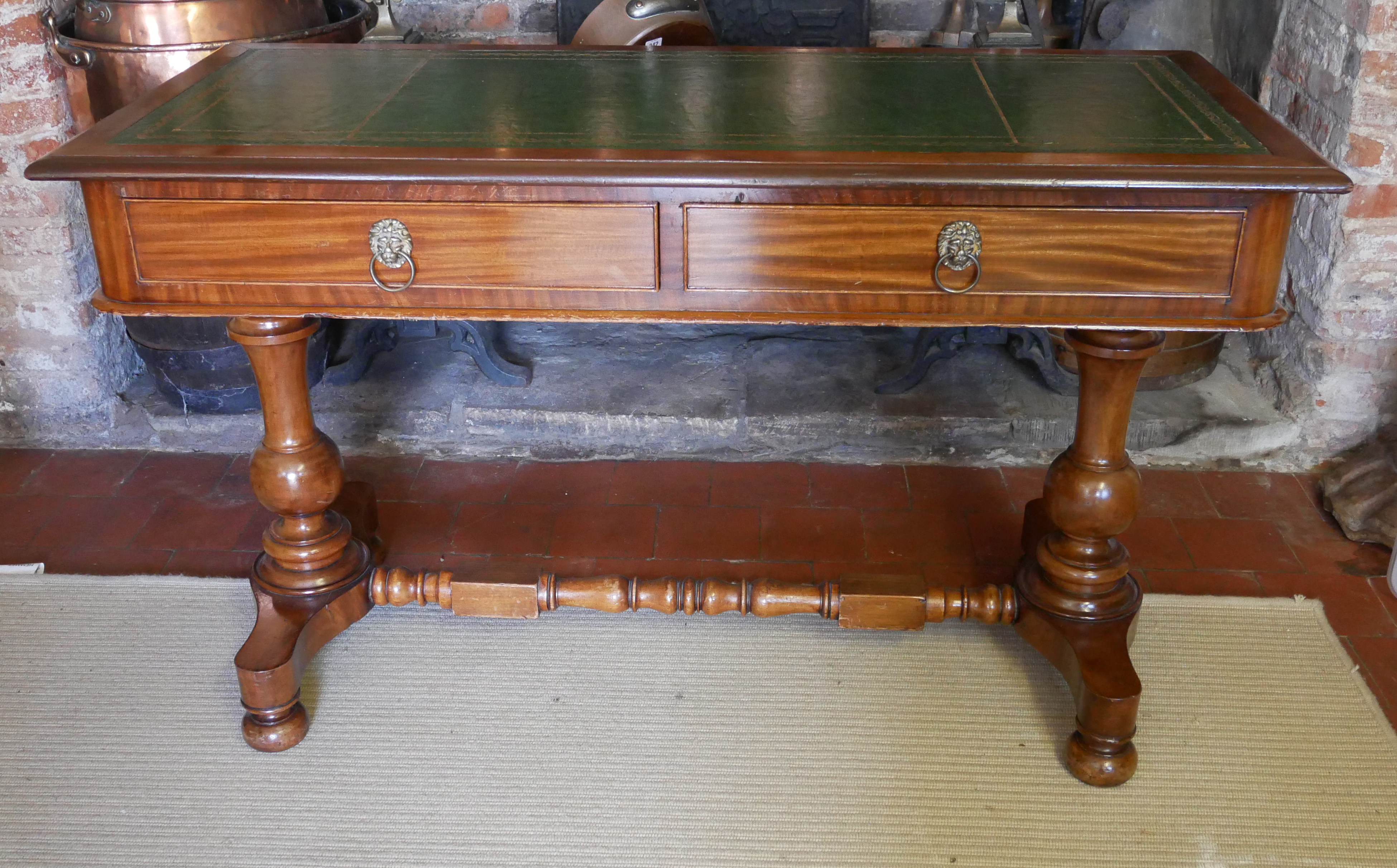 A VICTORIAN MAHOGANY WRITING TABLE With green tooled leather top above two drawers, raised on two