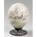 A 20TH CENTURY SCRIMSHAW OSTRICH EGG DEPICTING A WHALING SCENE. Signed J.A. Possibly a faux/