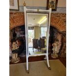 A 19TH CENTURY CHEVAL MIRROR The later white painted frame with turned finials and columns holding a