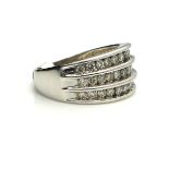 A WHITE METAL AND DIAMOND RING Three rows of round cut diamonds in a curved form mount (size R/