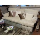 A PAIR OF GOOD QUALITY THREE SEATER SOFAS Upholstered in a cut cream fabric, complete with loose