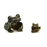 STUART DEVLIN, A SILVER NOVELTY MODEL OF A FROG Seated pose with one arm raised, hallmarked