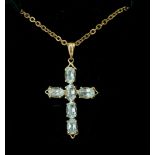 A 14CT GOLD AND AQUAMARINE CROSS PENDANT Oval cut stones in a gold frame with 9ct gold necklace
