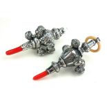 TWO CONTINENTAL SILVER AND CORAL TEETHING RATTLES Having whistle finials, engraved decoration and