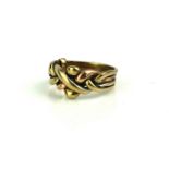 A 9CT BICOLOUR GOLD PUZZLE RING With yellow and rose gold entwined bands (size M).