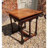 LIBERTY & CO. LTD, LONDON, A MAHOGANY CENTRE TABLE The square top above a shaped apron, raised on