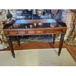 A VICTORIAN MAHOGANY WRITING TABLE With galleried back above three drawers, raised on turned