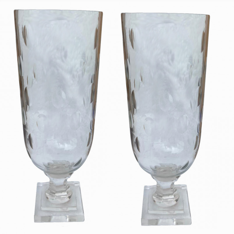 A PAIR OF CUT GLASS STORM LANTERNS With circular bodies, on stepped plinth bases. (31cm)