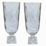 A PAIR OF CUT GLASS STORM LANTERNS With circular bodies, on stepped plinth bases. (31cm)