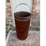 A LARGE REGENCY DESIGN MAHOGANY PEAT BUCKET With steel strap handle and liner contained in a