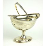 A GEORGIAN IRISH SILVER SUGAR BASKET Classical form with engraved floral swags and central