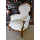 A 19TH CENTURY FRENCH ARMCHAIR Upholstered in a cream water silk, the mahogany frame with carved and