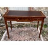 A CONTINENTAL LACQUERED WALNUT AND MAHOGANY WRITING TABLE With brown leather surface above three