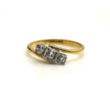 AN EARLY 20TH CENTURY 18CT GOLD AND DIAMOND THREE STONE RING Three graduating round cut diamonds