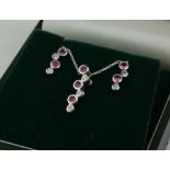 AN 18CT WHITE GOLD, DIAMOND AND PINK SAPPHIRE NECKLACE AND EARRINGS SET The pendant set with three