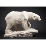 A MODERN STONE SCULPTURE OF A POLAR BEAR. Very heavy, possibly a cast. (h 24cm x w 36cm x d 16cm)