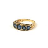 A VINTAGE 9CT GOLD AND AQUAMARINE FIVE STONE RING Graduated form with pierced frame (size Q).