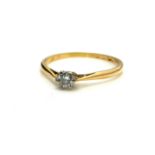A YELLOW METAL AND DIAMOND SOLITAIRE RING The round cut diamond on a plain gold mount (size R). (