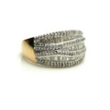 A 9CT GOLD BAGUETTE AND PAVE DIAMOND RING Three rows of baguette diamonds edged with pavé