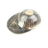 A STERLING SILVER 'JOCKEY CAP' CADDY SPOON Embossed decoration and shield form cartouche. (approx