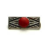 AN ART DECO DESIGN YELLOW METAL, RED CORAL AND DIAMOND BROOCH A circular coral disc edged with