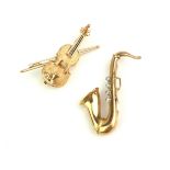 TWO 9CT GOLD AND DIAMOND 'MUSICAL INSTRUMENT' BROOCHES A saxaphone set with four round cut