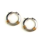 A PAIR OF 9CT BICOLOUR GOLD EARRINGS Circular form in white gold with bands of yellow gold, in a