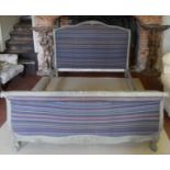 A 19TH CENTURY FRENCH PAINTED WOODEN DOUBLE BED The scrolled frame carved with floral decoration,