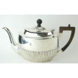A VICTORIAN SILVER TEAPOT Having ebonised wood finial and handle and half flutes to body, with