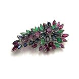 A VINTAGE WHITE METAL AND GEM SET DIAMOND BROOCH Having an arrangement of rubies, sapphires and