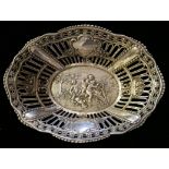 A CONTINENTAL SILVER SWEETMEAT BASKET The pierced trellis design with embossed figures to base,