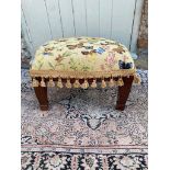 A TAPESTRY UPHOLSTERED STOOL Decorated with butterflies, on square tapering legs. (46cm x 35cm x