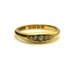 AN EARLY 20TH CENTURY 18CT GOLD AND DIAMOND FIVE STONE RING Having a row of graduating diamonds,