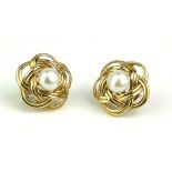 A PAIR OF 9CT GOLD AND PEARL EARRINGS Each set with a single pearl in a pierced mount. (approx