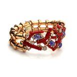 AN 18CT GOLD, DIAMOND AND CORAL BRACELET Four strands of red coral set with cabochon cut blue