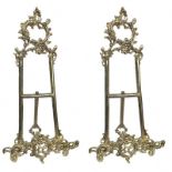 A PAIR OF SOLID BRASS PICTURE EASELS Pierced Rococo style decoration, on stand. (h 52cm)