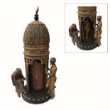 A COLD PAINTED BRONZE FIGURAL EROTIC GROUP ORNAMENT An Arabic tower with pierced gallery, two male