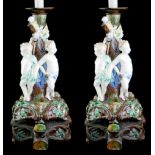A PAIR OF 20TH CENTURY MINTON MAJOLICA STYLE FIGURAL LAMP BASES MODELLED AS THREE PUTTI IN RELIEF