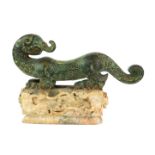 A CHINESE ARCHAIC DESIGN BRONZE AND HARDSTONE SCULPTURE OF A DRAGON Engraved and raised
