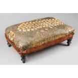 AN UNUSUAL LATE 19TH CENTURY TAXIDERMY CROCODILE SKIN FOOTSTOOL WITH EBONISED FEET AND VELVET