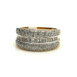 AN 18CT GOLD, BAGUETTE AND PAVÉ DIAMOND THREE ROW RING The single row of baguette cut diamonds