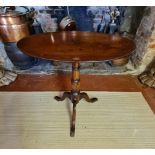 A 19TH CENTURY MAHOGANY AND OAK OCCASIONAL TABLE With oval tilt top raised on a single column with