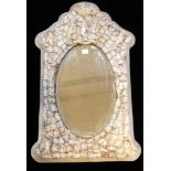 A 19TH CENTURY FRENCH IVORY FRAMED MIRROR Figured with a cherub flanked by dragons above an oval