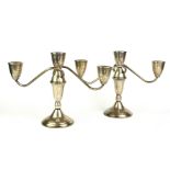 A PAIR OF STERLING SILVER CANDELABRA Sectional form with circular base, marked to base 'Sterling