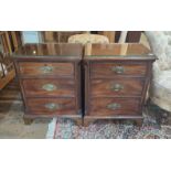 A PAIR OF 19TH CENTURY MAHOGANY PEDESTAL CHESTS Three rolls fitted with brass furniture flanked by